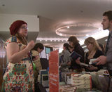 Alumni Epsilon member, Tania Richter, working the book sale table at the 2013 Convention